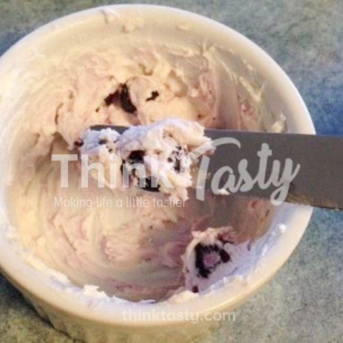 Goat cheese, cream cheese, and blueberries mixed to form a spread