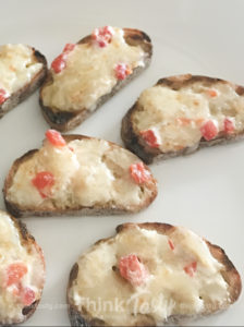 Crostini topped with hot pimento cheese
