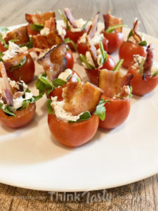 Cherry tomatoes stuffed with bacon, lettuce, and cheese